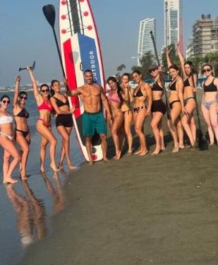 Group beach workout with paddle boards